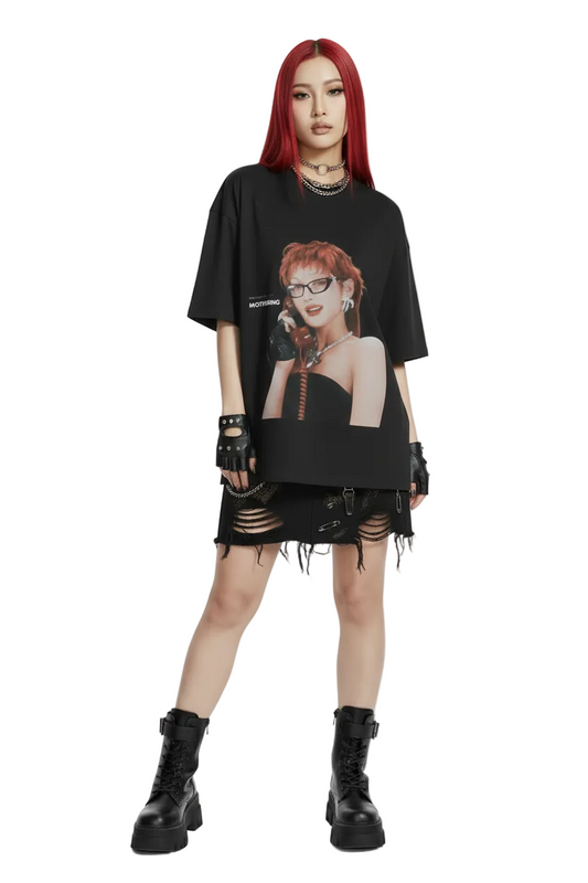 Black t-shirt with a graphic of a woman with red hair and glasses on a white background