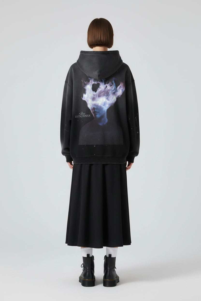 Black hoodie with a graphic design on the back featuring a person with a cloud-like head and text 'Being Human'.