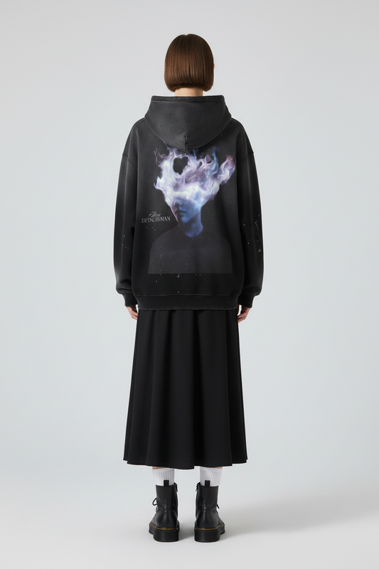 Black hoodie with a graphic design on the back featuring a person with a cloud-like head and text 'Being Human'.