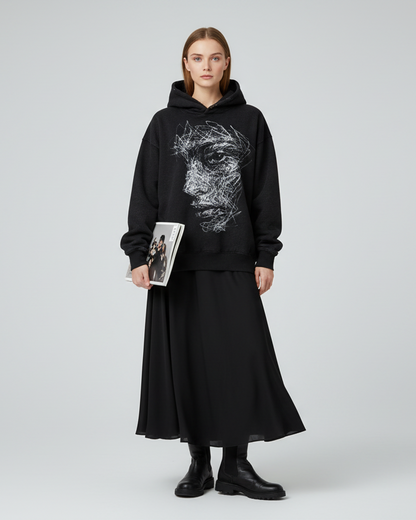 Black hoodie with a unique face design on a white background