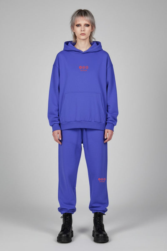 Person wearing a blue hoodie and pants with red text on a gray background