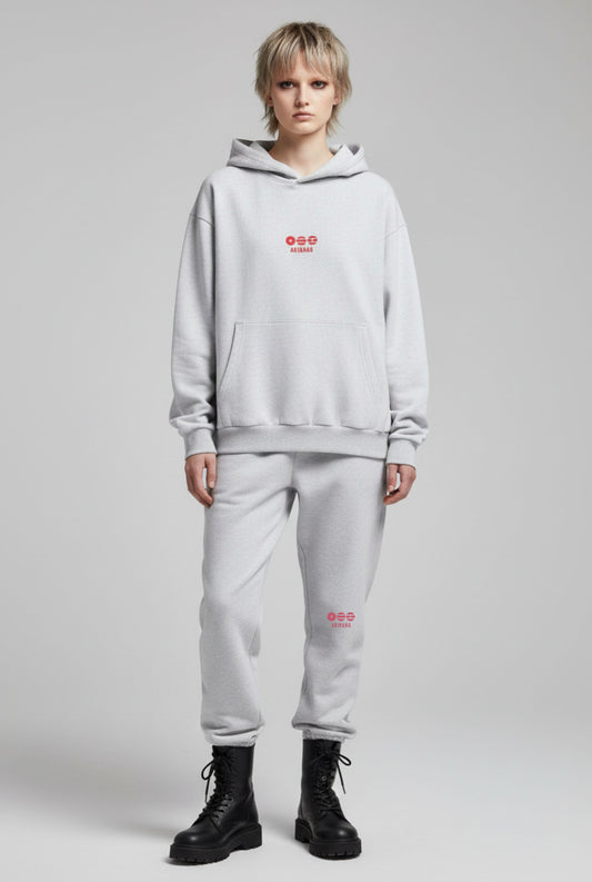 Person wearing a light gray hoodie and pants with red text on a gray background