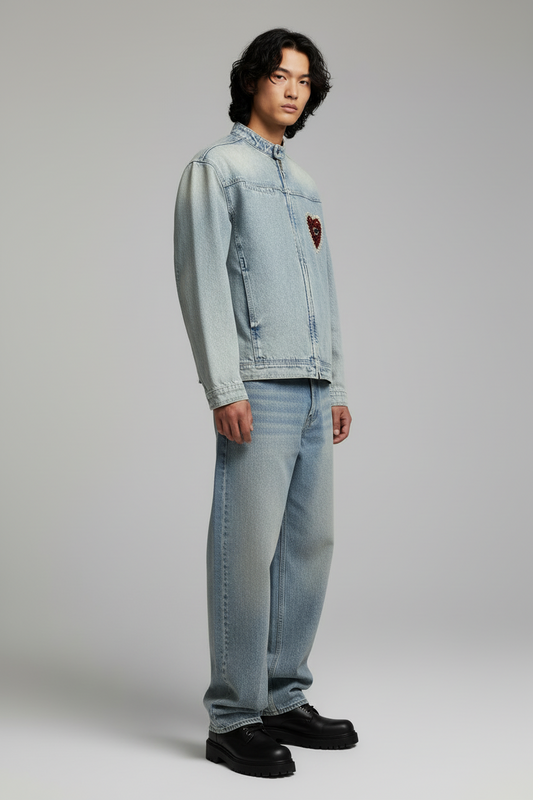 Light blue denim jacket with a red heart patch on a white background