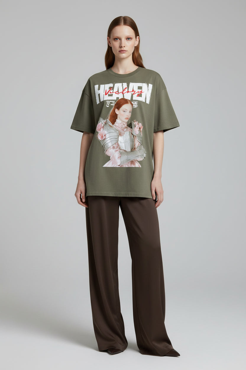 Green t-shirt with graphic design of a woman in armor and flowers, and 'Heaven' text.