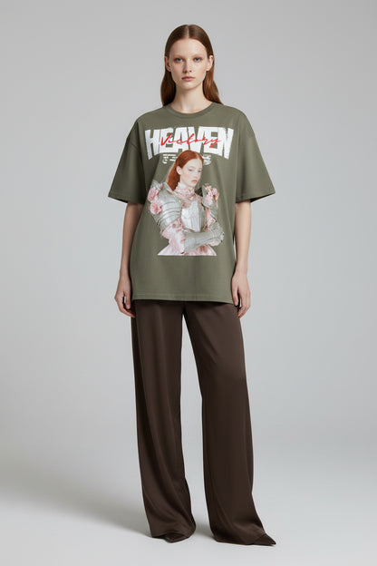 Green t-shirt with graphic design of a woman in armor and flowers, and 'Heaven' text.