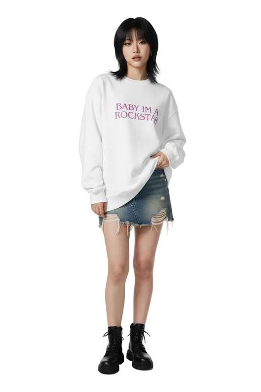 White sweatshirt with 'BABY IM A ROCKSTAR' text in pink on a white background