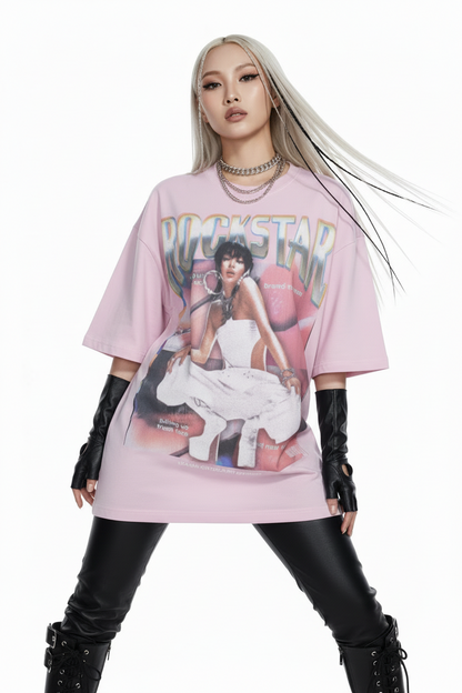 Pink t-shirt with a graphic design of a woman in a white dress and 'Rockstar' text on a white background