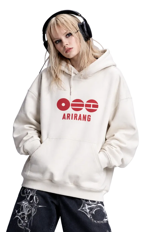 Person wearing a white hoodie with red logo and text, black shorts, and black boots on a light gray background