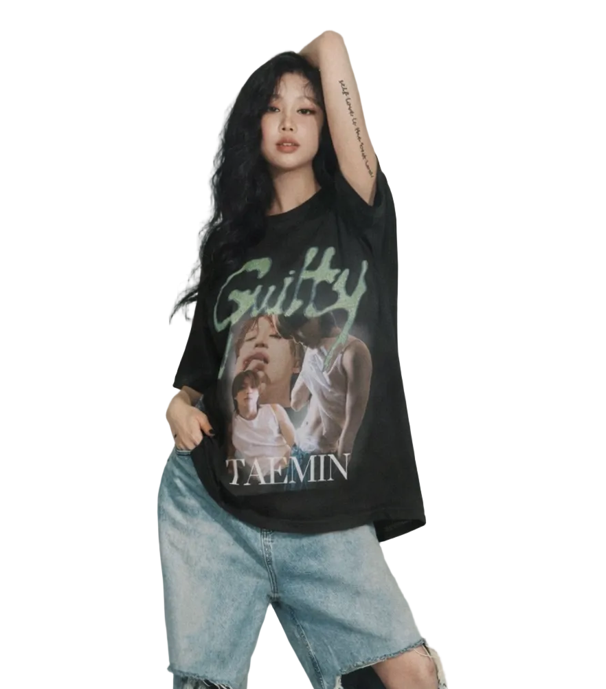 Person wearing a graphic t-shirt and ripped jeans on a white background