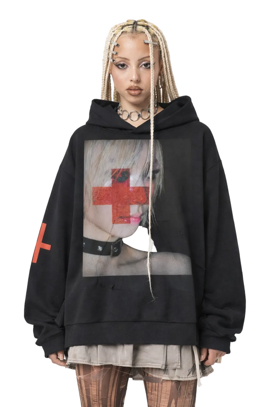 Person wearing a black hoodie with graphic design on a white background