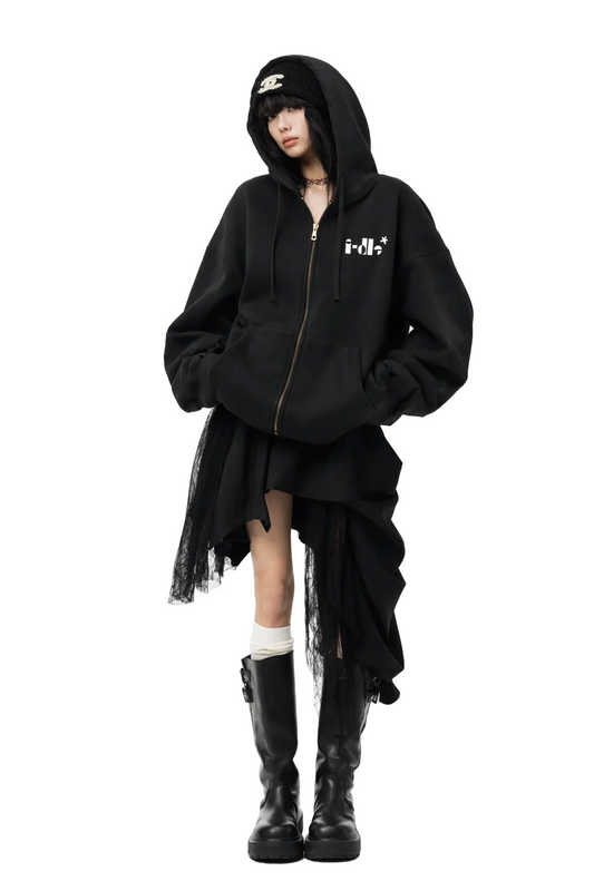 Person wearing a black hoodie, skirt, and boots on a white background