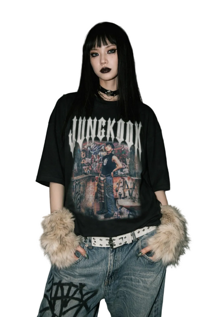 Person wearing a black 'Jungkook' t-shirt in a graffiti-covered room