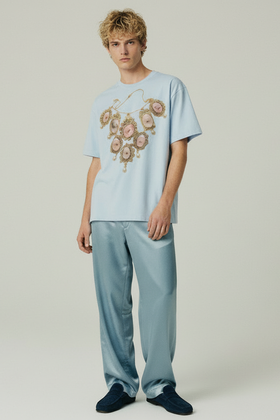 Light blue t-shirt with a decorative necklace design on a white background