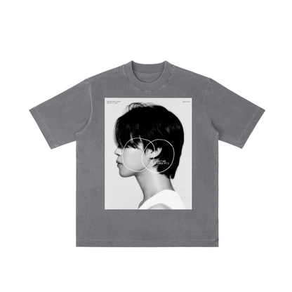 Gray t-shirt with a graphic of a person with short hair and a minimalistic design on a white background