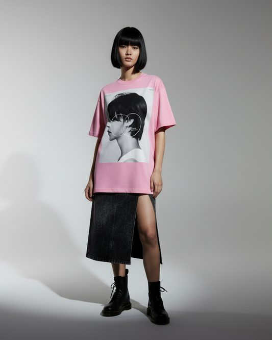 Pink t-shirt with a graphic of a person's profile on a white background