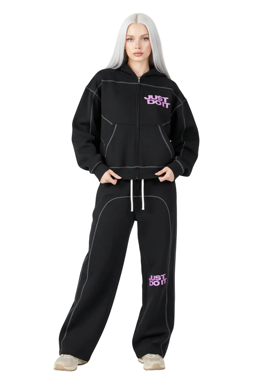 Person wearing a black tracksuit with 'Just Do It' text on a white background