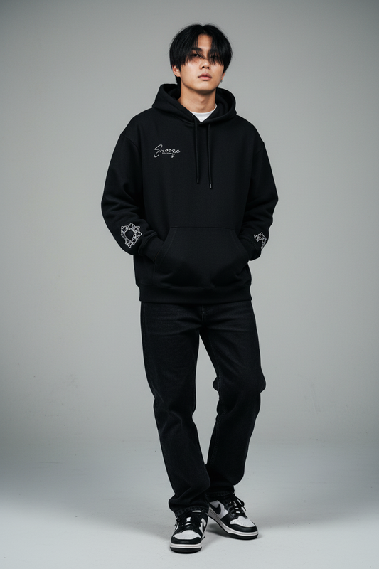 Black hoodie with white branding and patterns on a white background