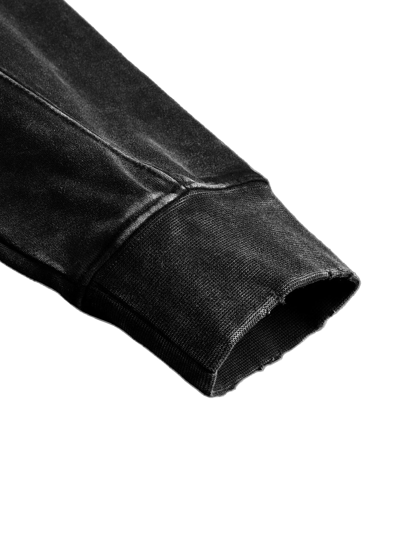 Close-up of a black sleeve with a white background