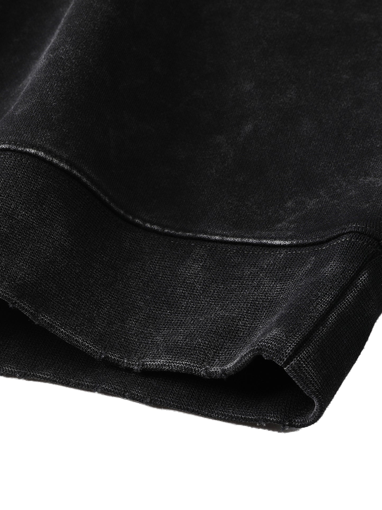 Close-up of black fabric with a subtle texture on a white background