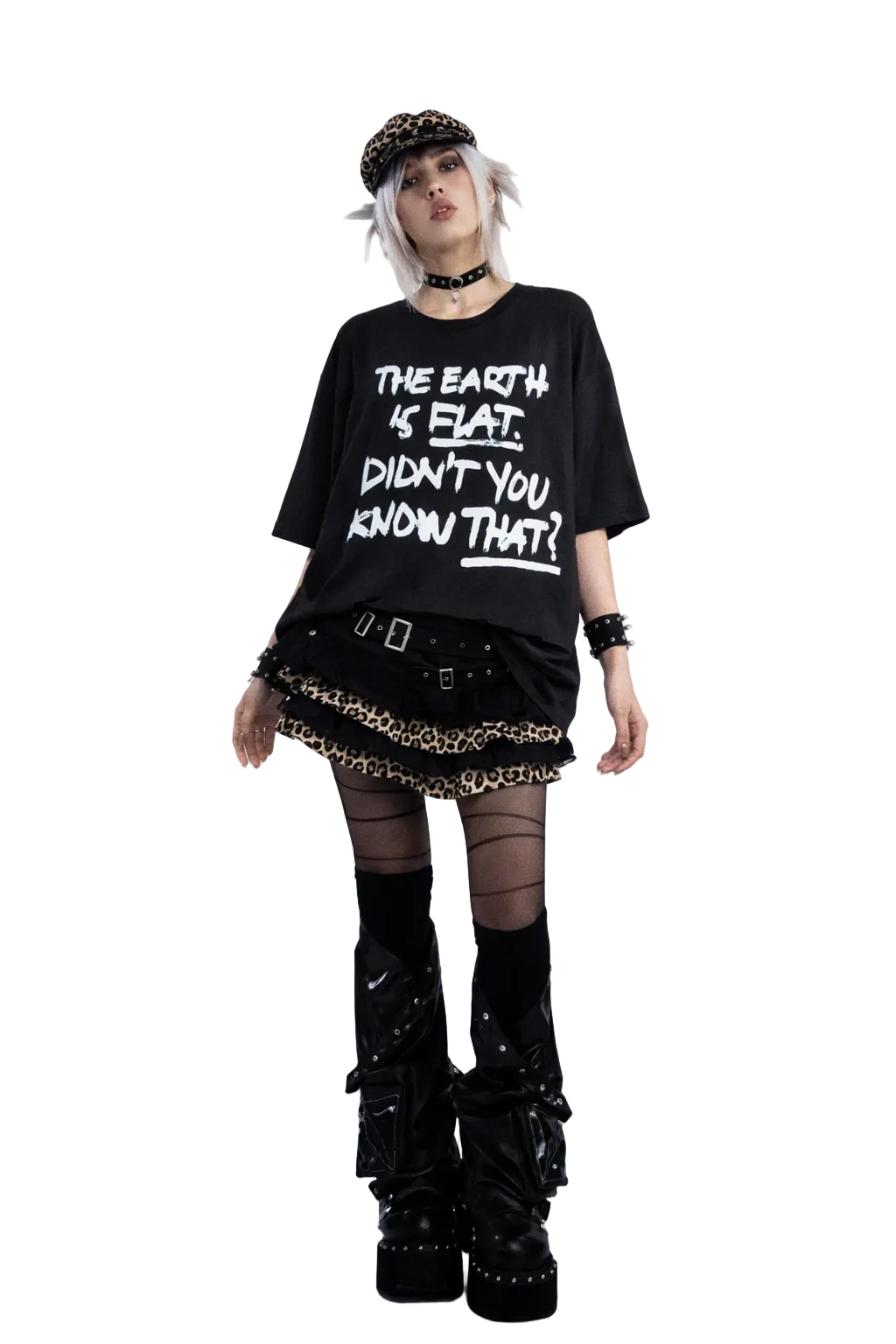 Person wearing a black t-shirt with text, skirt, and boots on a gray background