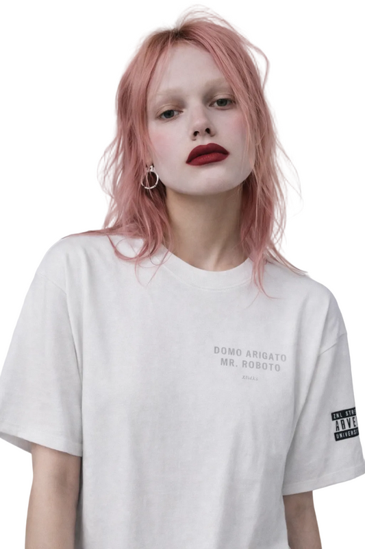 Person wearing a white t-shirt with text on a plain background